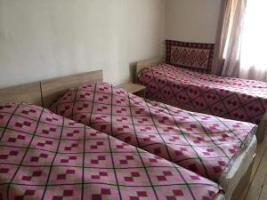 Letto o letti in una camera di Tishe