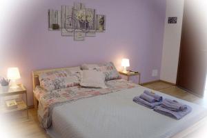 a bedroom with a bed with towels on it at Dependance Miluna in Nettuno