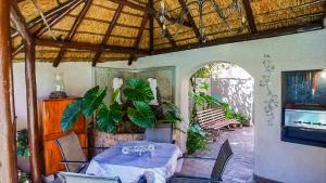 a dining room with a table and some plants at 52 Oaks Guest House in Sasolburg