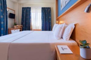 Letto o letti in una camera di Alexandra Hotel