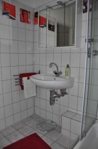 a white bathroom with a sink and a mirror at Appartment in Troisdorf-Sieglar in Troisdorf