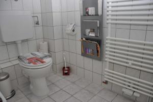 a bathroom with a toilet with a book on it at Appartment in Troisdorf-Sieglar in Troisdorf
