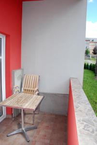 a bench sitting on a porch next to a wall at Apartmán Jeseník in Jeseník