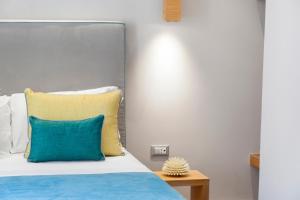 A bed or beds in a room at La Piazzetta Guest House