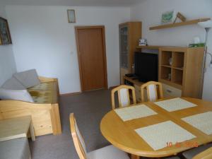 a living room with a table and a dining room at Apartmány Hágy L+L in Vysoké Tatry