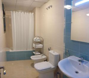 a bathroom with a toilet and a sink at Apartamentos Prado in Peniscola