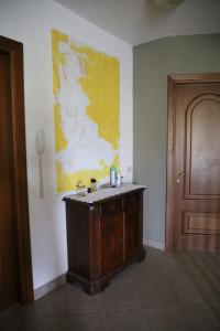 a bathroom with a sink and a painting on the wall at Villa Naclerio in Sarzana