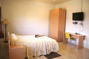 Ένα ή περισσότερα κρεβάτια σε δωμάτιο στο Rainville Apartments