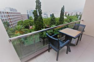 a patio area with a table and chairs at Karaca Hotel in İzmir