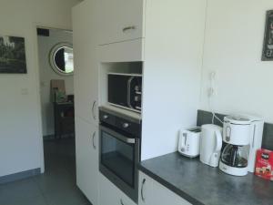 a kitchen with a microwave and a coffee maker at Grand appartement proche CHU in Rouen