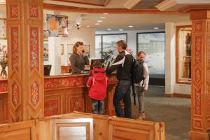 a group of people standing at a counter at Résidence Odalys Val-Claret in Tignes