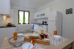 a kitchen with a table with plates on it at KAYSERSBERG city center - COTE VIGNOBLE - in Kaysersberg