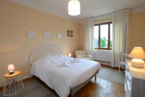 a bedroom with a large white bed and a window at KAYSERSBERG city center - COTE VIGNOBLE - in Kaysersberg