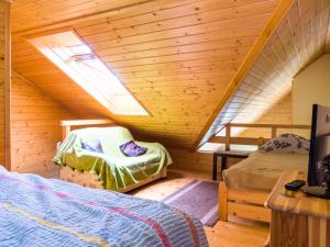 a attic room with a bed and bunk beds at Apartamenty Osiedle Belweder in Wisła