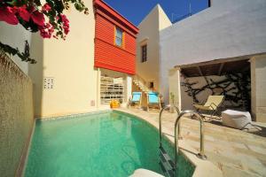 a swimming pool in the middle of a house at Veranda Rossa Suites in Rethymno Town