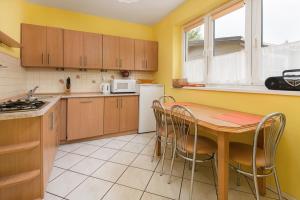 a kitchen with a table and chairs and a microwave at FOR YOU dom dla 10 osób in Białogóra