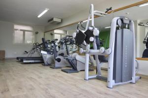 a gym with a bunch of treadmills and machines at Hotel Nibaru in Porto Cervo
