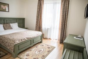 Säng eller sängar i ett rum på Pensiunea Panoramic