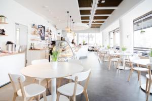 a row of tables and chairs in a restaurant at Hostel Café Koti in Rovaniemi