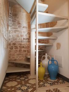 a staircase in a room with vases on the floor at Casetta del Pescatore in Polignano a Mare