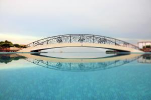 a bridge over a body of water at Kaliakria Sea View Apartments in Topola