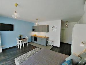 a living room with a kitchen and a dining room at Apartamenty Retmana in Krakow