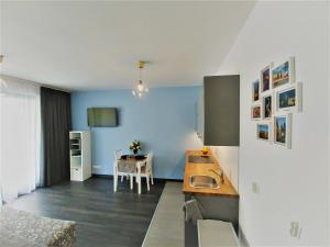 a kitchen with a sink and a table at Apartamenty Retmana in Krakow