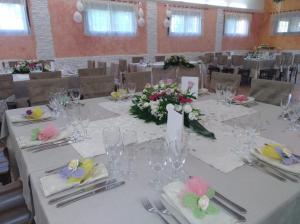a dining room with a table with flowers on it at Masseria La Guardata in Guglionesi