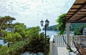 a porch with a street light and a view of the water at Villa Luciana in Mimice