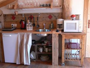 a kitchen with a sink and a microwave at A la Bouge'Hôtes in Bellentre