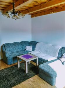 a living room with a couch and a table at Apartman pod Kalváriou - rodinný dom in Banská Štiavnica