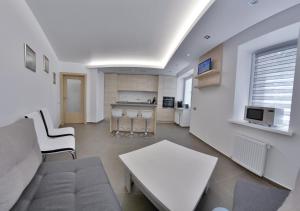 a living room with a couch and a table at Apartment OneClickRent_05 - Smart House in Chişinău