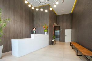 a woman standing at a counter in a lobby at Lima Walking Apartments - Central Miraflores in Lima