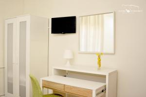 Uma televiso e/ou sistema de entretenimento em Alecrim Rosmaninho Guest House