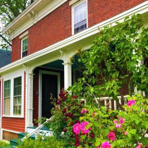 a red brick house with flowers in front of it at The Water Street Inn in Kittery