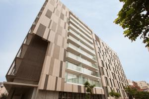 a tall apartment building with a large window at Lima Walking Apartments - Central Miraflores in Lima