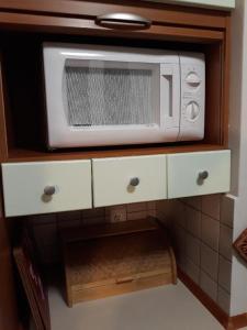 a white microwave sitting on top of a cabinet at Apartament Park in Słupsk +34 photos