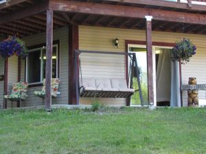 a porch with a bench on the side of a house at Peaceful 3 bdrm Alaskan getaway in Wasilla