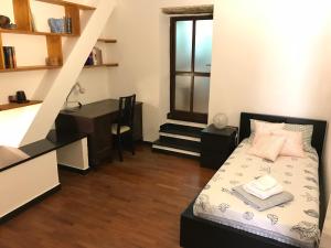 a bedroom with a bed and a desk in it at Casa Alba in Monterosso al Mare