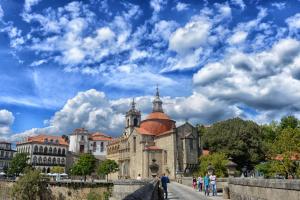 um edifício antigo com um céu azul com nuvens em Hotel Navarras em Amarante