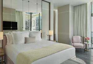 a hotel room with a bed and a television at SLS LUX Brickell in Miami