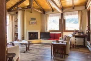 a living room with a couch and a fireplace at Tasos House in Kalabaka