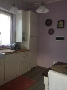 a kitchen with white cabinets and a counter top at Lovely Versilia Tuscany in Torre del Lago Puccini