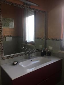 a bathroom with a sink and a large mirror at Lovely Versilia Tuscany in Torre del Lago Puccini
