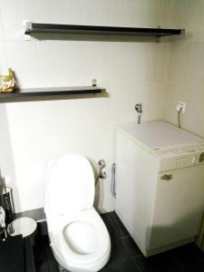 a bathroom with a white toilet and a sink at Sweet Maisonette in Perea +11 photos