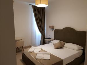a bedroom with a bed with white sheets and pillows at Villa Natia in Mottola +33 photos