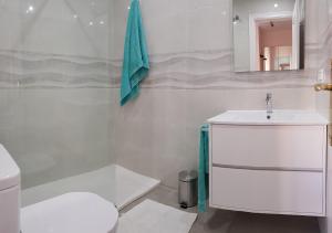 a bathroom with a sink and a toilet and a mirror at AZAHARA 20 in Nerja +15 photos
