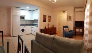 a living room with a couch and a kitchen at AZAHARA 20 in Nerja