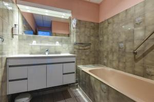uma casa de banho com um lavatório e uma banheira em Hotel des Pyrénées em Font-Romeu