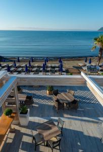 a view of a beach with chairs and umbrellas at Mandala Seafront Suites in Laganas